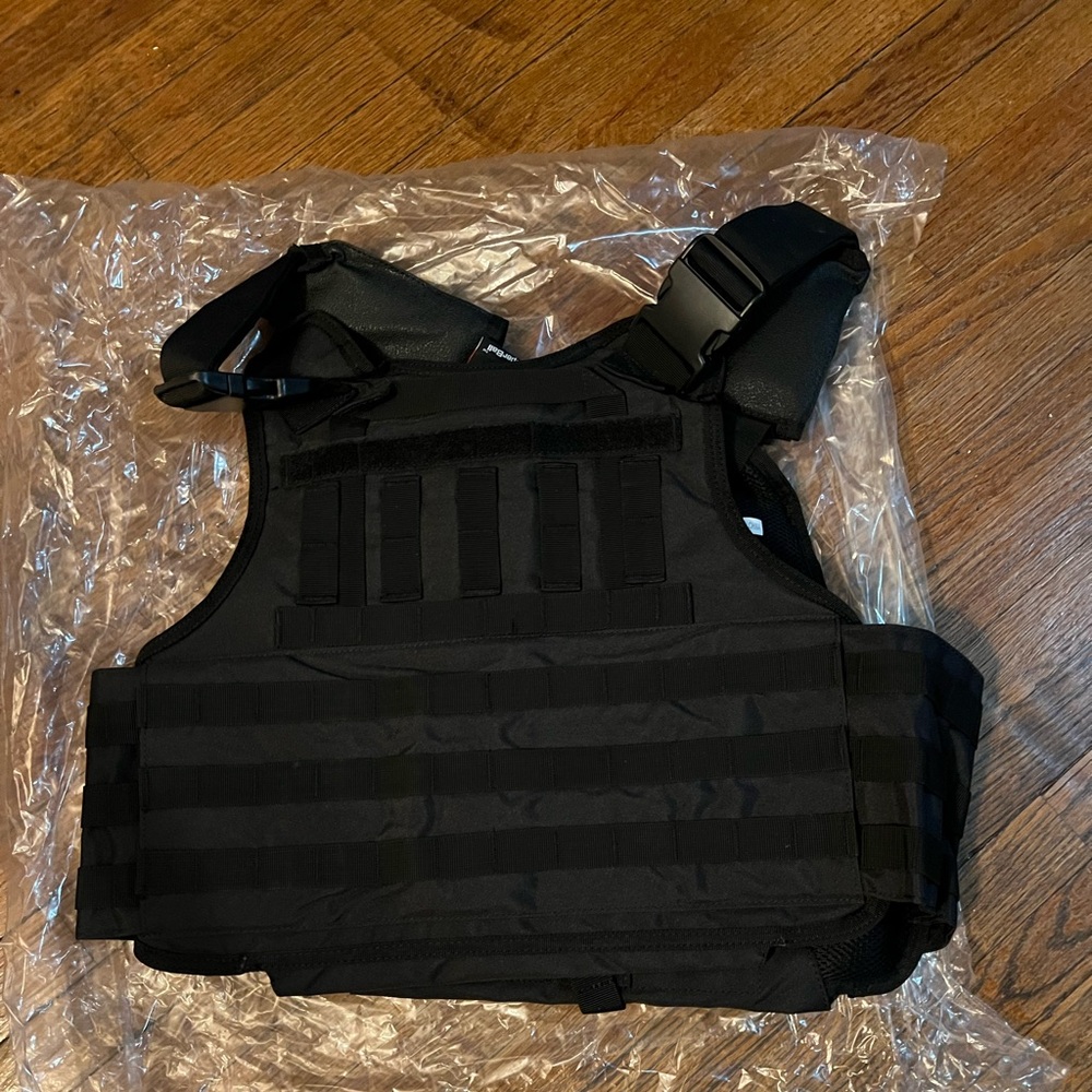Black tactical ballistic vest.  Does not have plates in it.